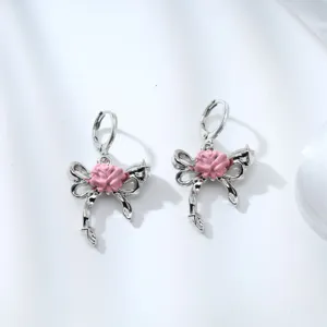 Detailed close-up of sweet silver alloy earrings featuring a pink flower bow design and secure clasp.