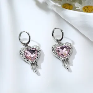 Detailed close-up view of pink heart crystal melting design silver earrings showcase.