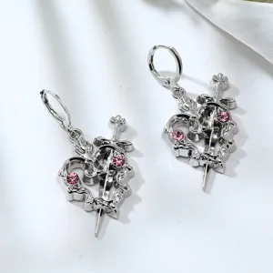 Detailed close-up of alloy pink rhinestone cross heart earrings, showcasing gothic punk style.