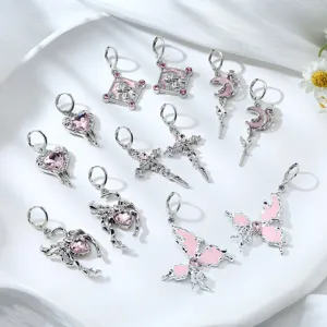 Cute Y2K pink rhinestone silver alloy earrings with cross, heart, and butterfly charms detail view.