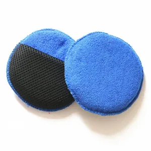 Car waxing sponge detail view, blue microfiber and black mesh pad for polishing.