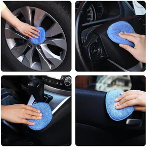 Detail view showing blue car waxing sponge cleaning wheels, steering wheel and interior dashboard safely.