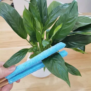 Close-up detail showing blue microfiber cleaning brush cleaning dust in narrow gaps easily.