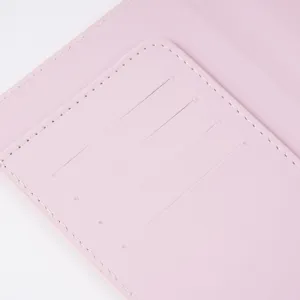 Pink PU leather passport holder detail close-up, showing multiple card slots and neat stitching.