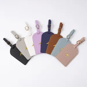 Colorful PVC luggage tags with gold airplane embroidery, durable travel suitcase accessory.