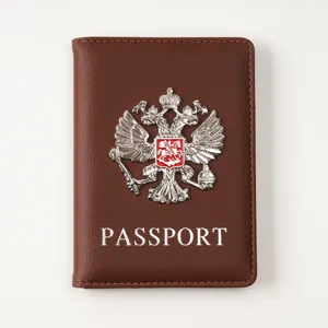 Brown PU leather passport cover detail with metallic double-headed eagle emblem.