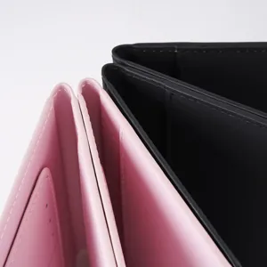 Detail shot of PU leather passport covers in pink and black, showing fine stitching and slots.