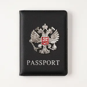Black PU leather passport cover with metal double eagle emblem and card slots for travel.