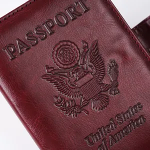 Embossed dark red PU leather passport cover detail, showing eagle stamp and texture.