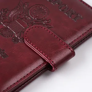 Burgundy PU leather passport cover detail, magnetic clasp and fine stitching design.