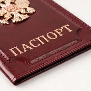 Vintage leather passport cover with metal badge and classic design for travel protection.
