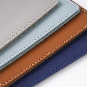 Detailed shot of multi-color leather passport holders with neat white stitching close-up.