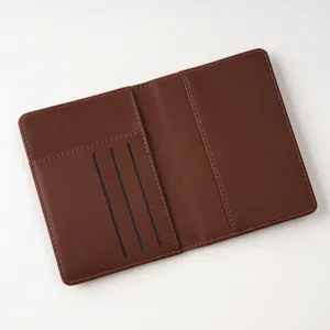 Brown PU leather passport cover detail showing multiple card slots and passport compartment.