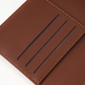 Brown PU leather passport wallet card slot detail close-up, premium stitching texture.