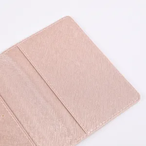 Close-up detail of pink PU leather passport holder interior with card slots and fine stitching.