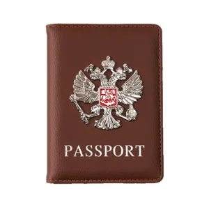 Brown PU leather passport cover with metal double eagle badge and card slots for travel.
