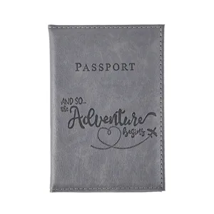 Grey PU leather passport cover detail showing travel quote debossed design and white stitching