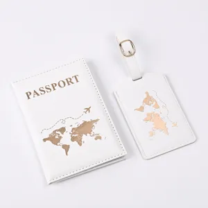 Detail shot of a white PU leather passport cover and luggage tag set with gold world map.