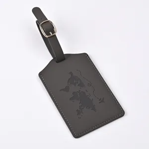 Detailed view of dark grey PU leather luggage tag featuring debossed world map and metal buckle.