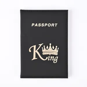 Close-up detail of black PU leather passport cover with white lettering and golden king logo.