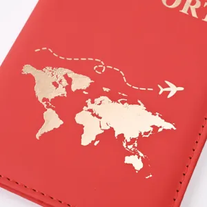 Detailed view of red PU leather passport cover with elegant gold foil world map and flight design.