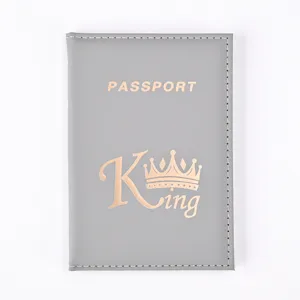 Detailed view of grey PU leather passport holder with gold King crown print and stitching.