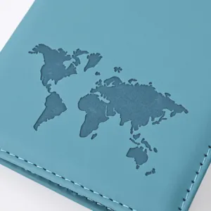 Close-up detail of teal PU leather passport cover featuring an embossed world map and neat stitching.