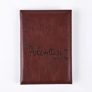 Detail view of dark brown PU leather passport cover with exquisite embossed travel quote texture.