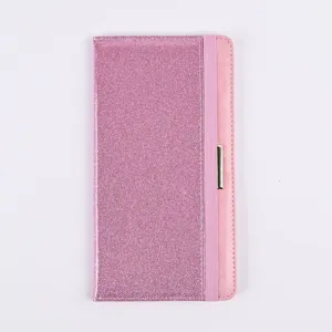 Detailed view of pink glitter PU leather passport cover with elastic band and metal accent.