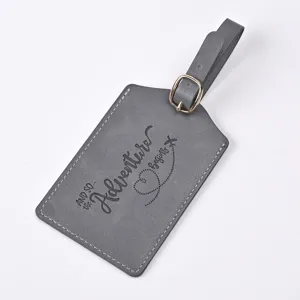 Grey PU leather luggage tag close-up, engraved adventure quote, durable travel accessory id.