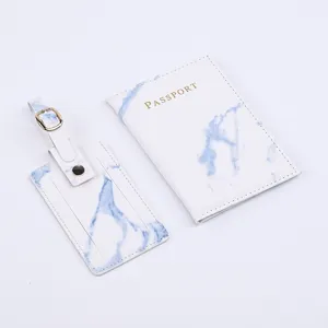 Detailed view of white marble pattern PU leather passport holder and matching luggage tag set.