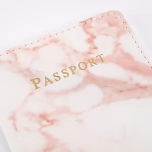 Pink marble passport holder detail view, stylish travel document organizer cover.