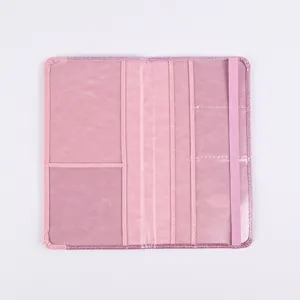 Pink PU leather passport cover detail showing internal card slots and a secure elastic strap.