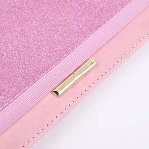 Pink PU leather passport cover with glitter detail, elastic band and gold metal bar.