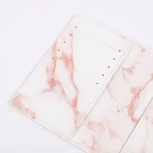Pink marble passport cover detail, PU leather travel document holder, card slot closeup.