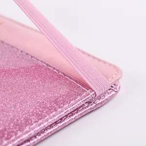 Close-up detail of pink sparkly PU leather passport holder with elastic band and stitching.