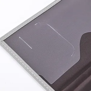 Close up detail of the minimalist PU leather passport holder transparent card slot interior.