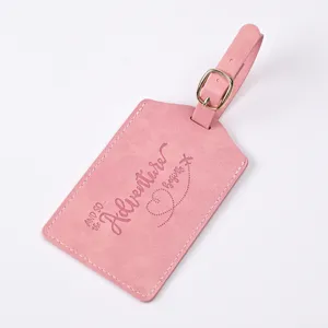 Pink PU leather luggage tag with embossed travel quote and metal buckle, durable travel accessory.