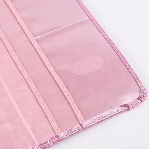 Close-up detail of pink glitter PU leather passport card holder interior slots and stitching.