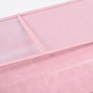 Pink PU leather passport holder detail showcasing fine stitching and clear card slots.