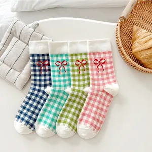 Cute gingham crew socks with red bow detail, soft cotton knit for daily wear, vibrant colorful style.
