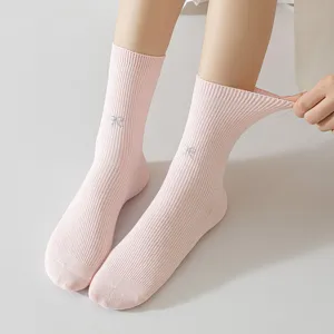 Pink ribbed mid-tube socks for women, featuring cute bow embroidery. Soft cotton daily wear.