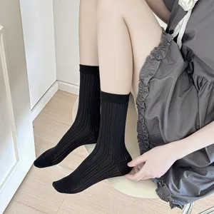 Detailed view of women's black mid-calf mesh socks, breathable vertical stripes for summer.