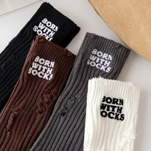 Distressed knit crew socks with embroidered letter details, casual cotton hosiery for women.