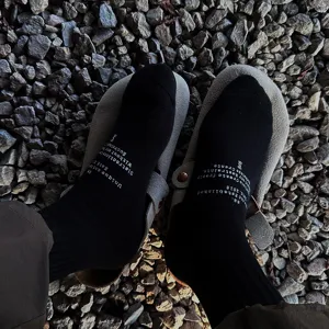 Men's casual solid cotton mid-tube socks with stylish letter print, breathable streetwear style.