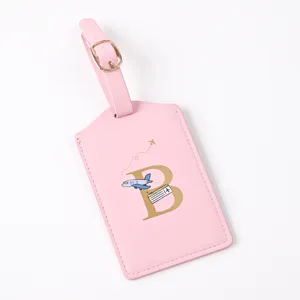 Pink PU leather travel luggage tag with gold letter B, airplane pattern, durable suitcase label.