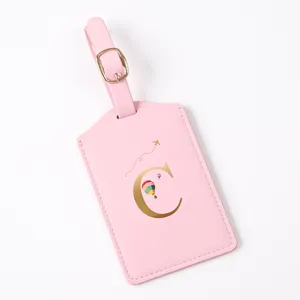 Pink travel luggage tag with gold letter C monogram, stylish suitcase ID label and accessory.
