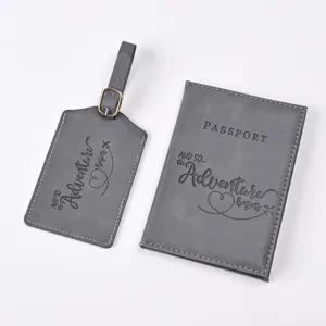 Grey PU leather passport cover and luggage tag set with embossed adventure text detail.
