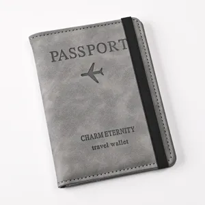 Grey PU leather passport wallet with elastic band detail view showing travel branding