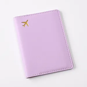 Close-up detail of the pastel purple PU leather passport cover with gold foil airplane.